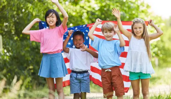 usa-kids-flag-labor-day Multicultural group of kids waving with US flag on Labor Day