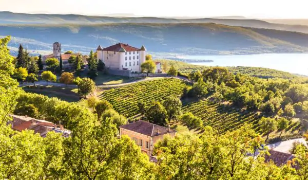 provence-france-chateau View of Village Aiguines and renaissance style chateau overlooking Lac de Sainte Croix Lake in Alpes de Haute Provence,France